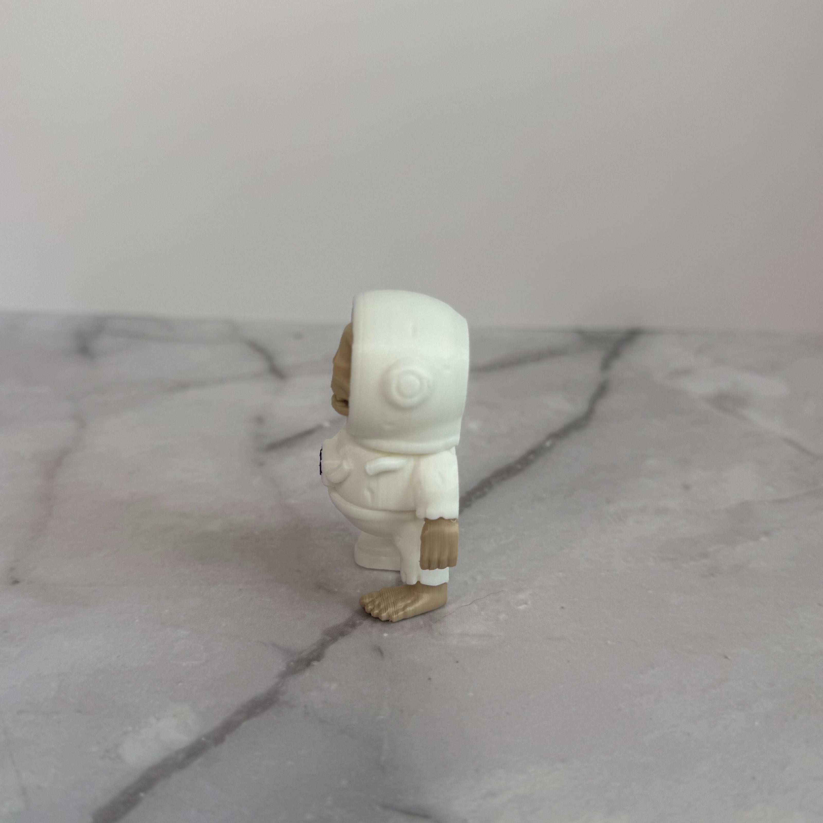 Small figure of a skeleton in an astronaut suit on a light gray background