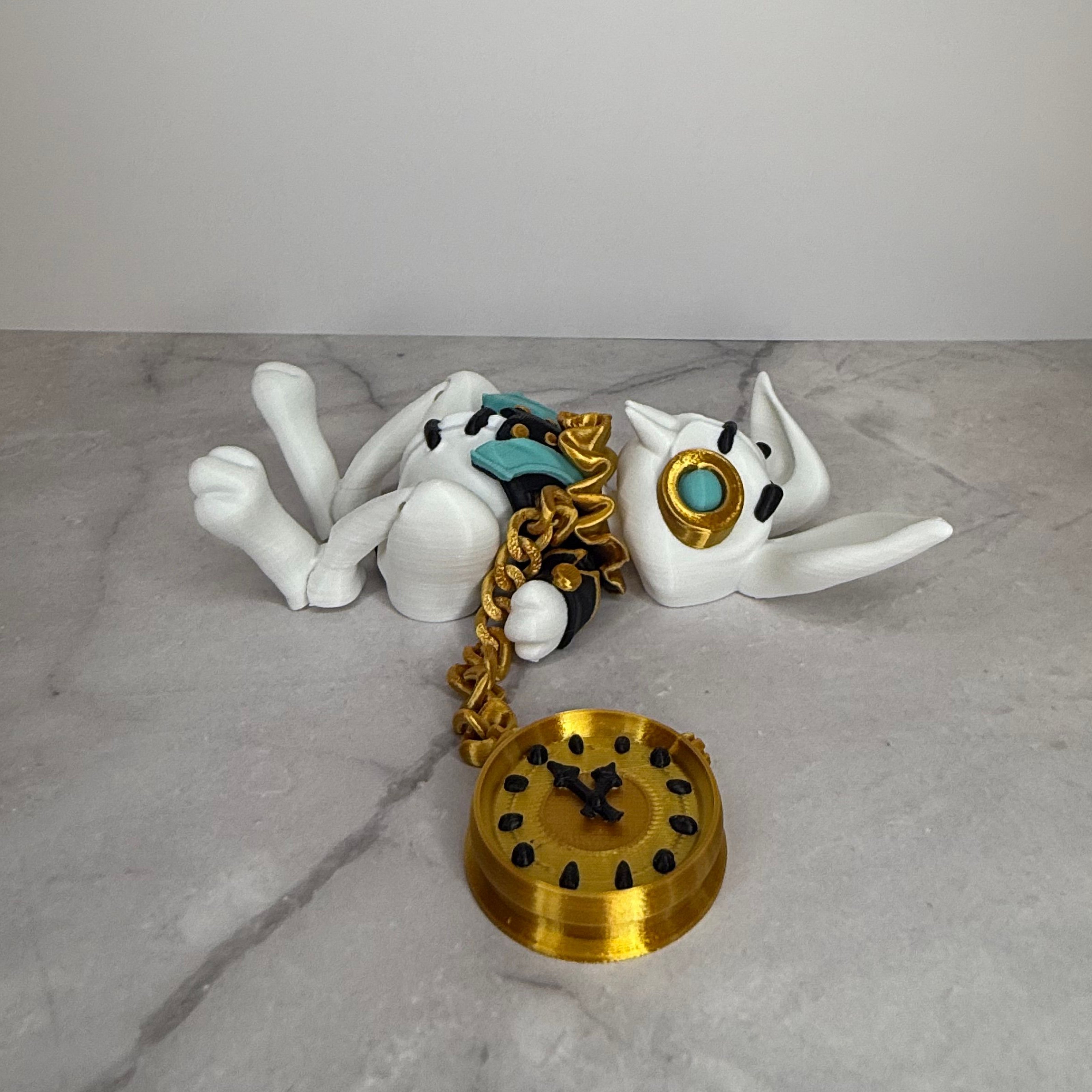 White rabbit figurine with gold chain and clock on a gray surface