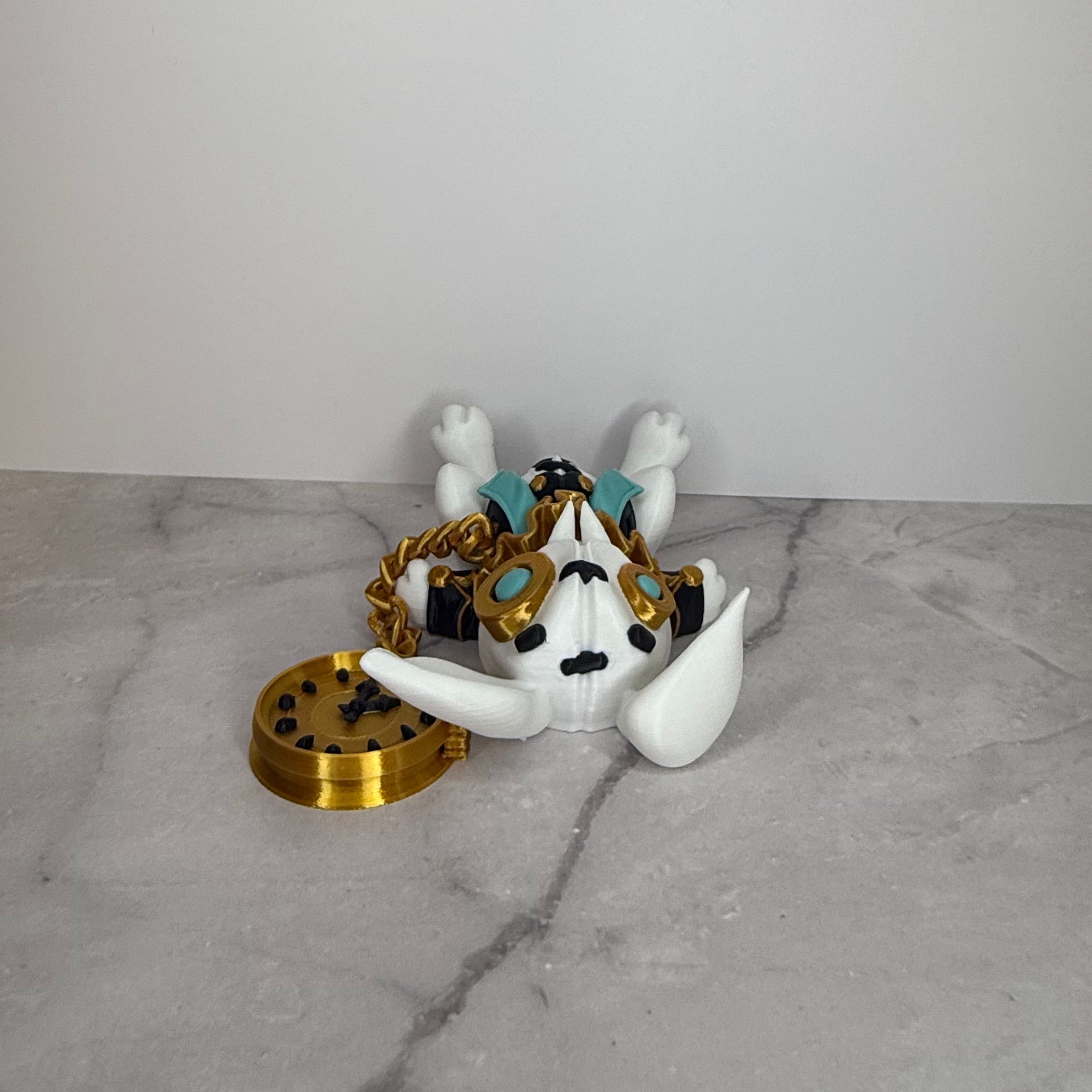 White figurine with gold and black accessories on a gray surface