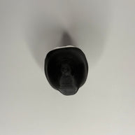 Top side of figure in black robe on a gray background