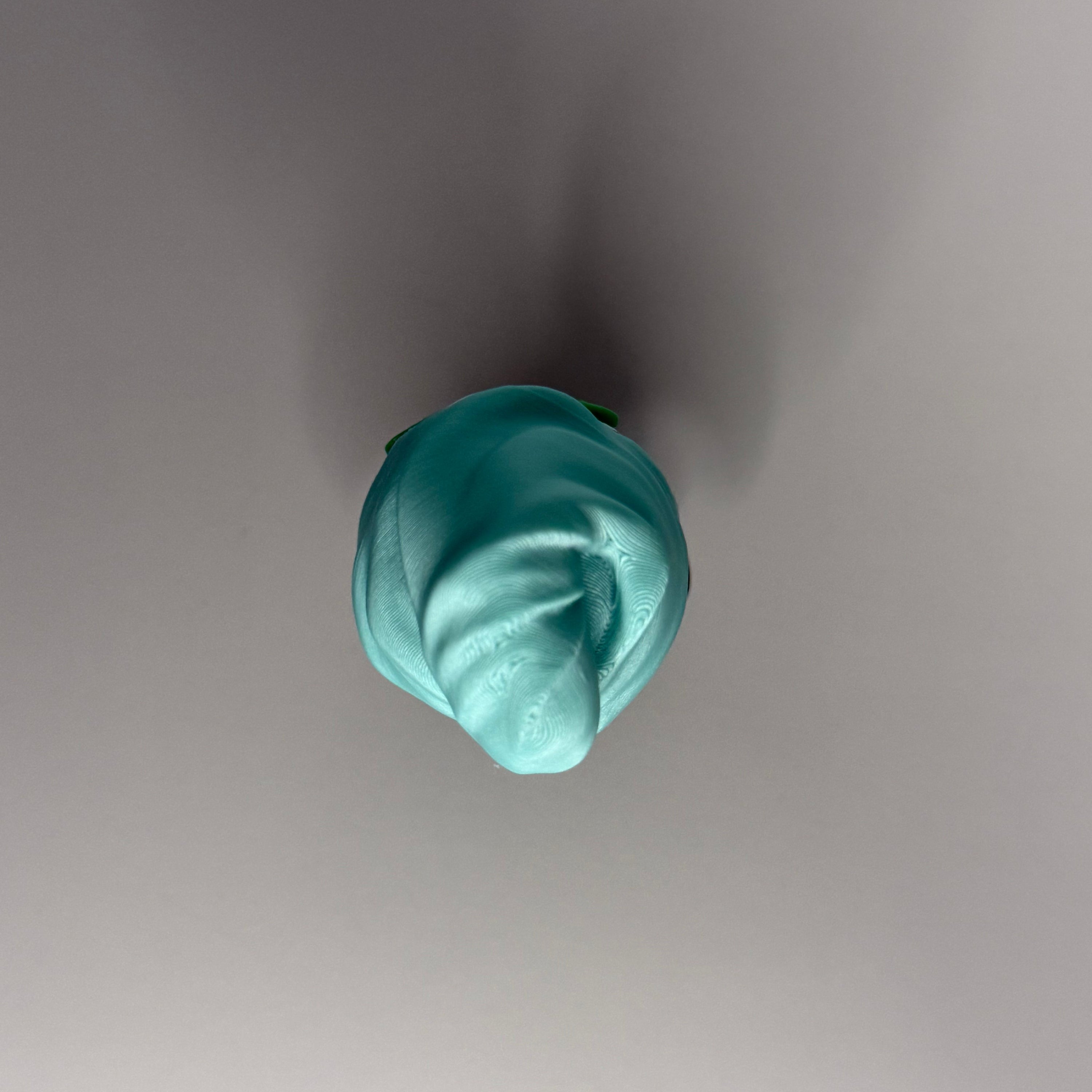 Top perspective of figure with teal head-towel