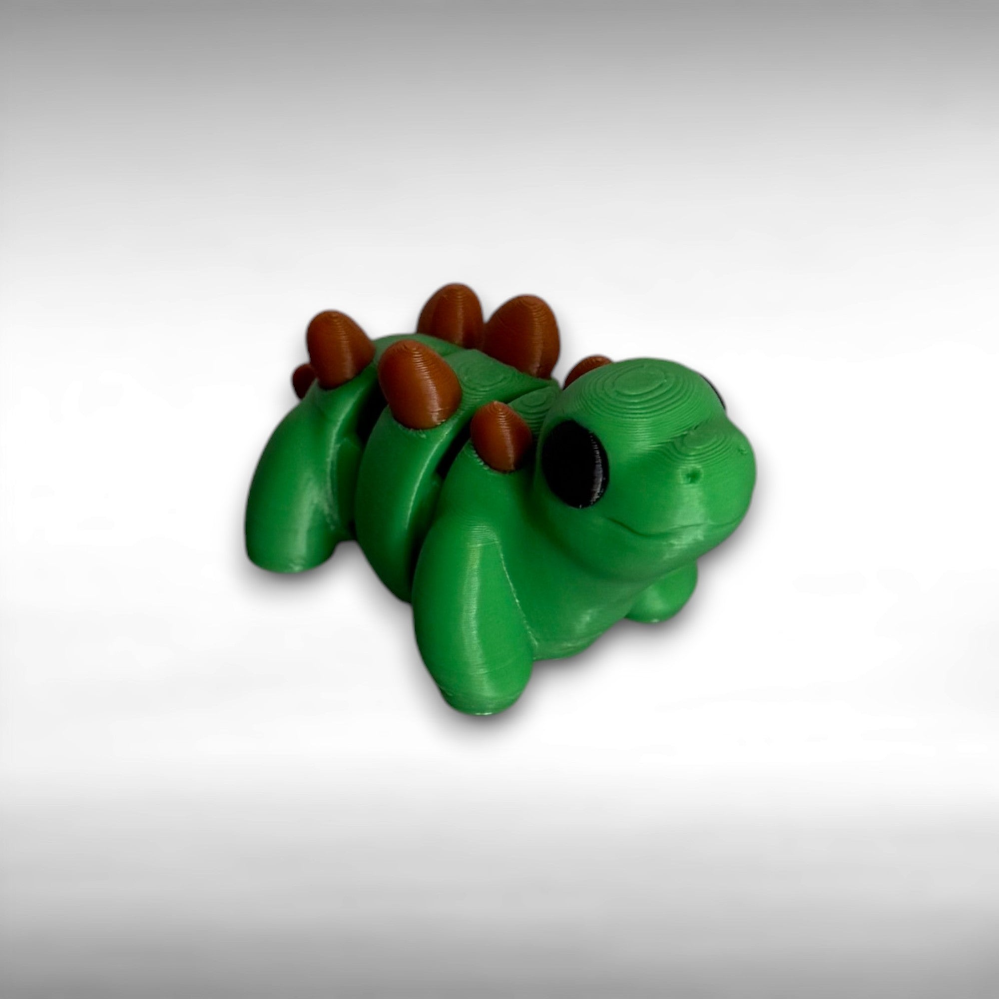 Green dinosaur with brown bumps on its back on a gray background