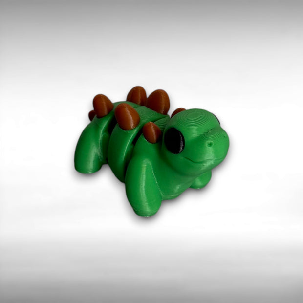 Green dinosaur with brown bumps on its back on a gray background