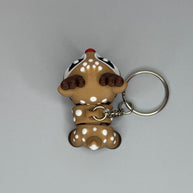 Top perspective of a reindeer-shaped keychain with a red, shimmer nose on a gray background