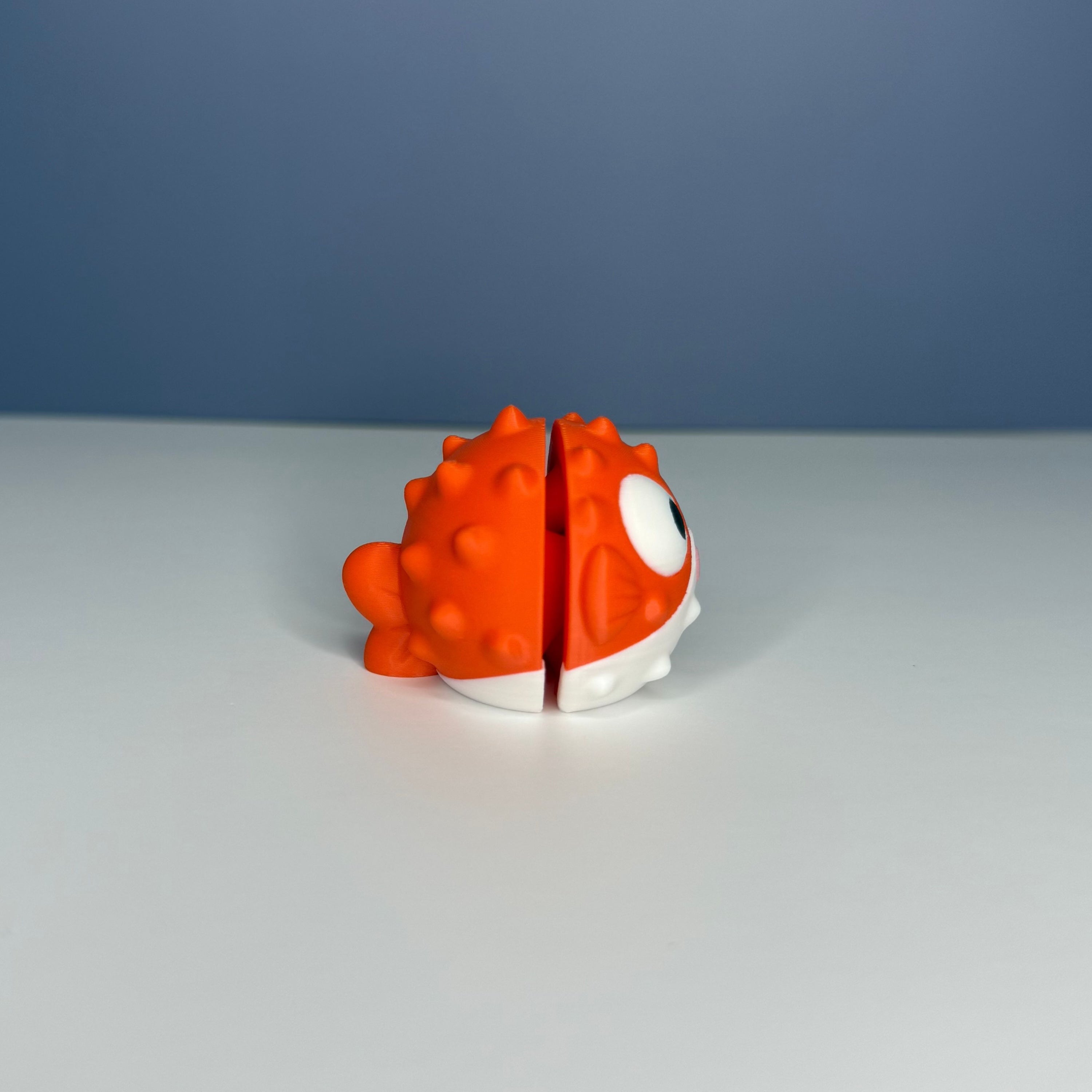 Side of an orange and white puffer fish figure on a blue and white background