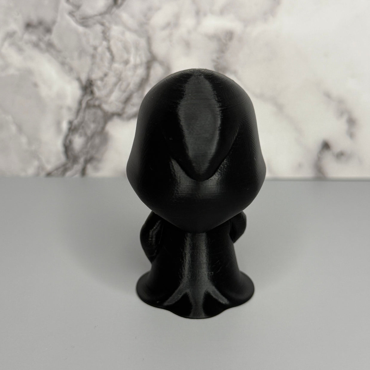 Back side of figure in black robe