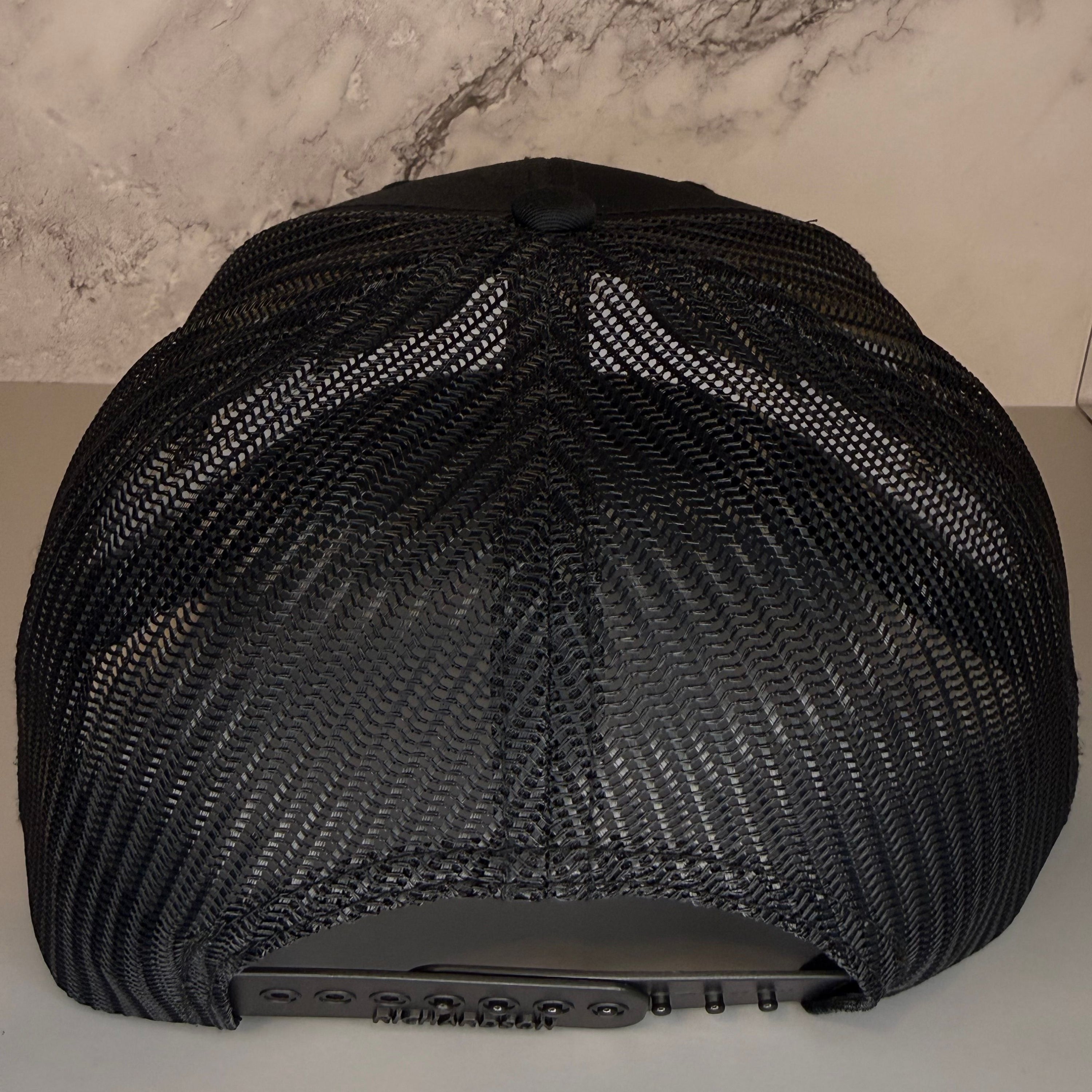 Black mesh cap on a neutral background