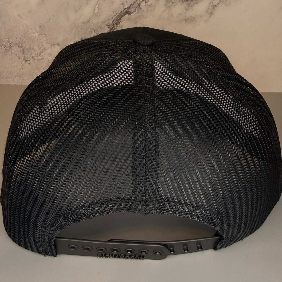 Black mesh cap on a neutral background