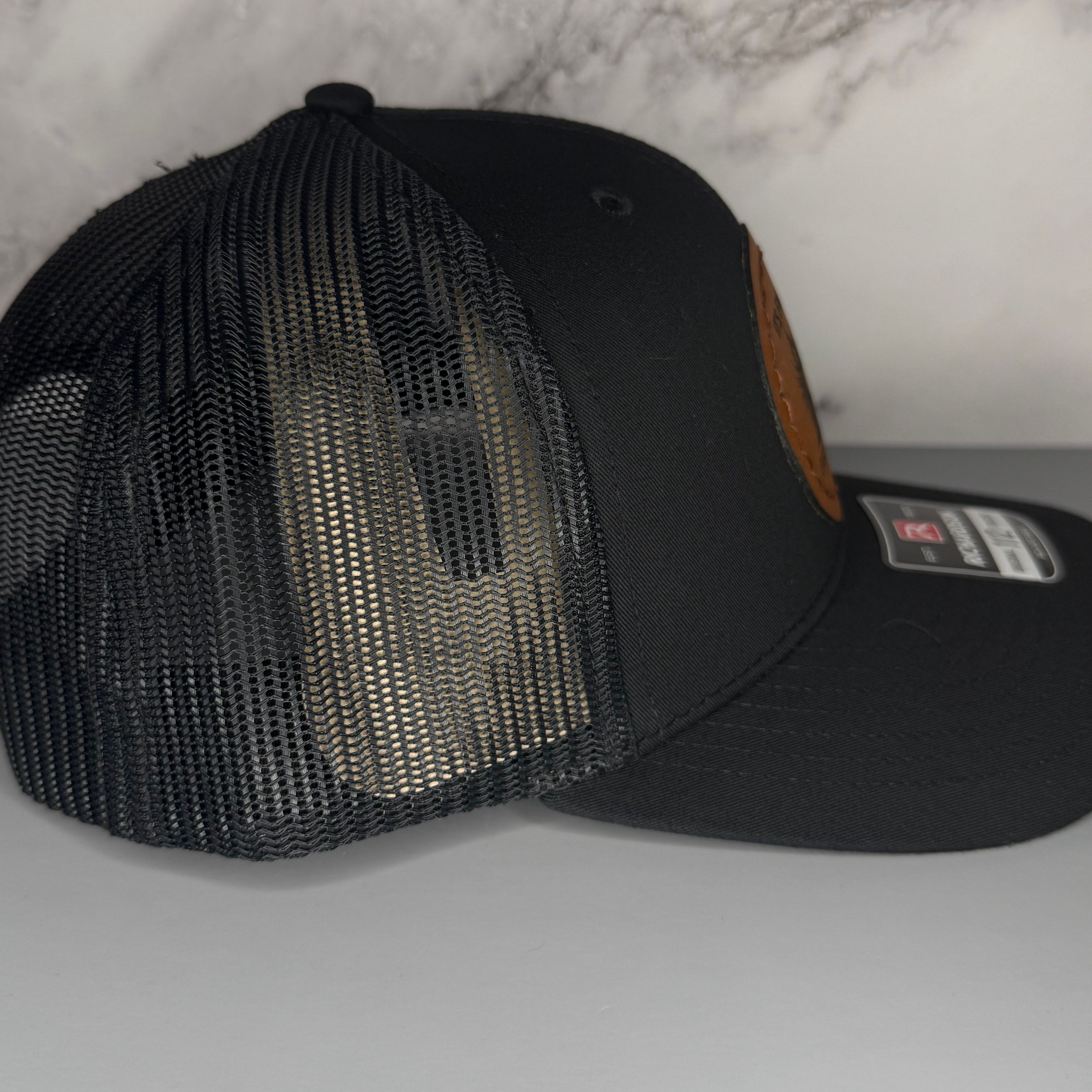 Black mesh cap on a light gray background