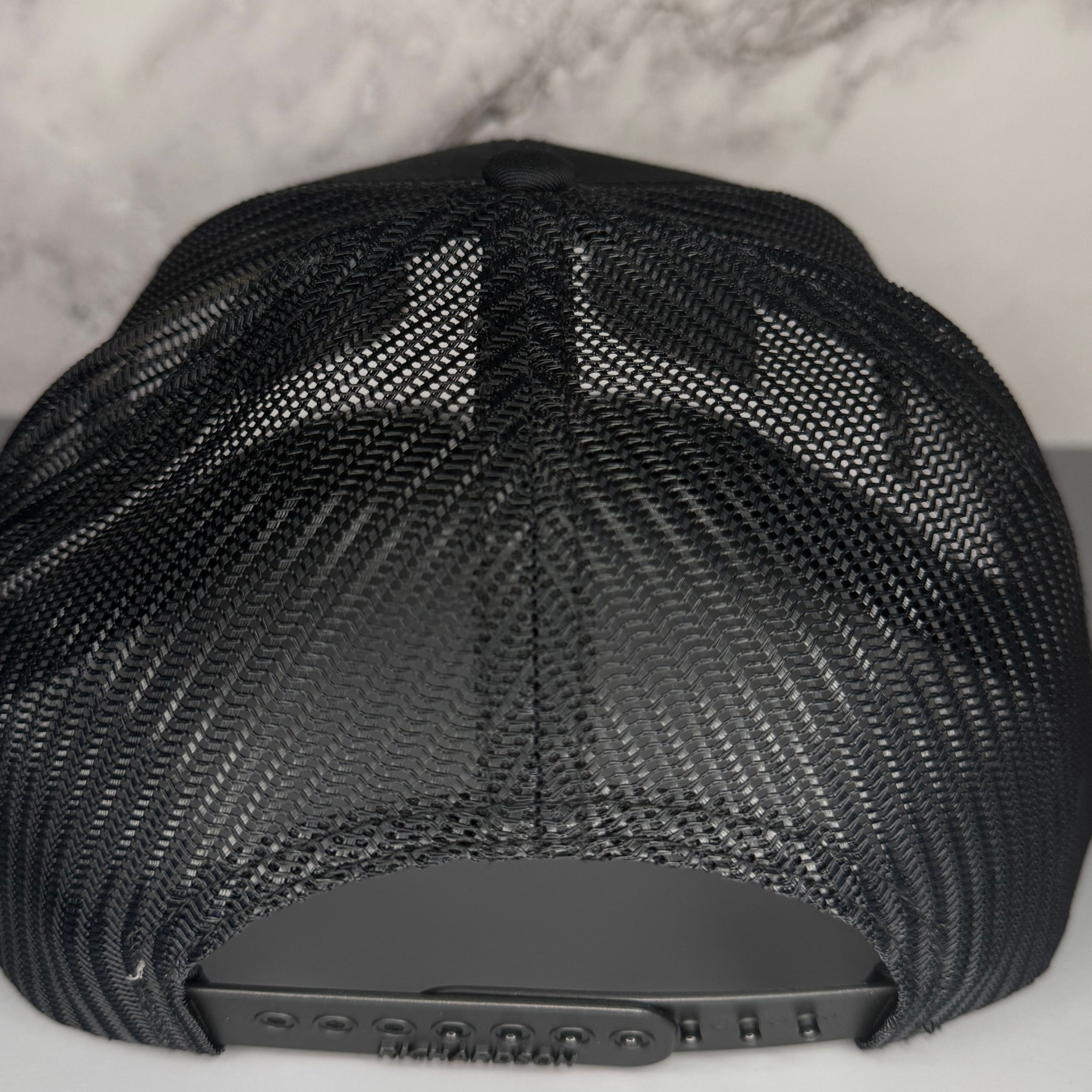 Black mesh cap on a light gray background