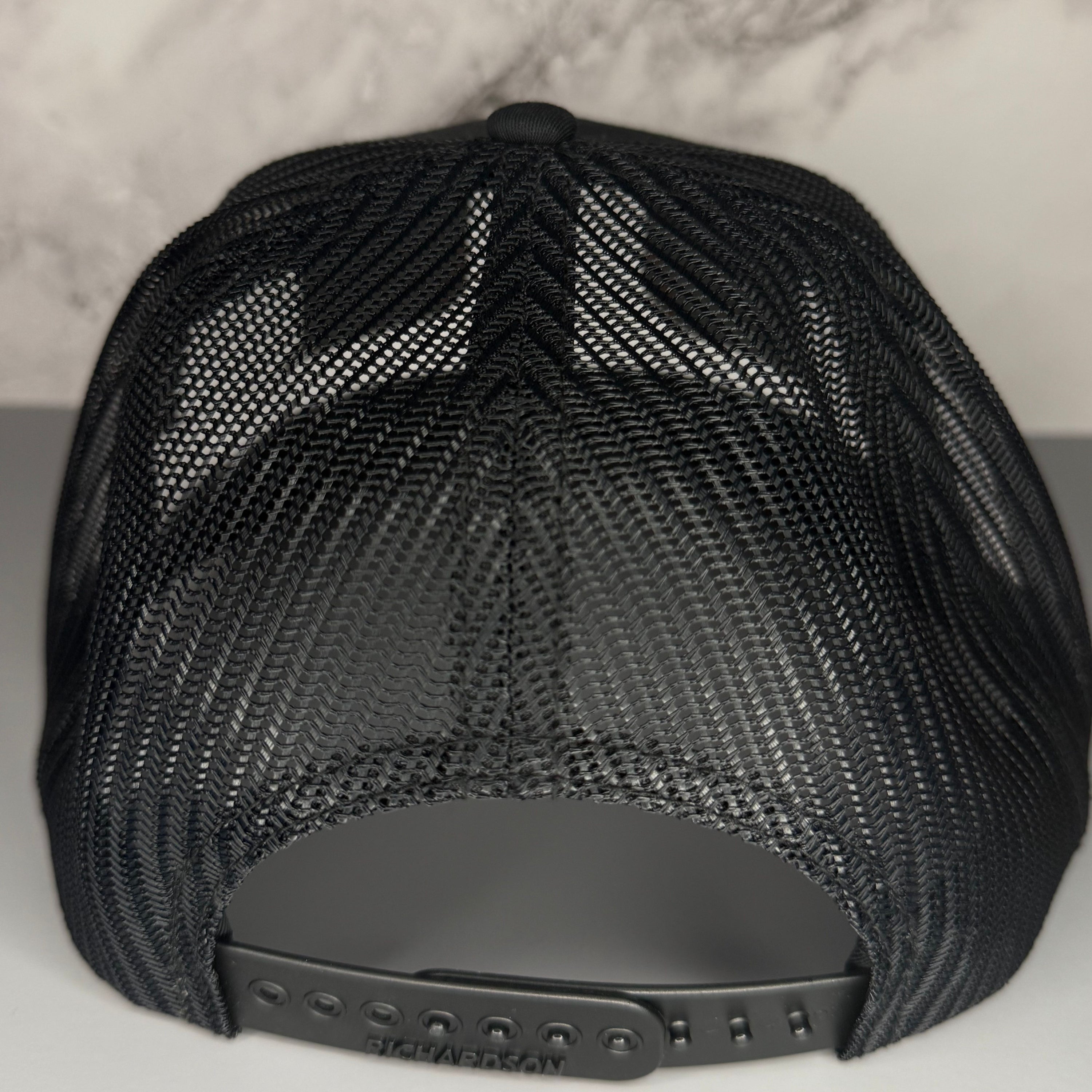 Black mesh cap on a light gray background