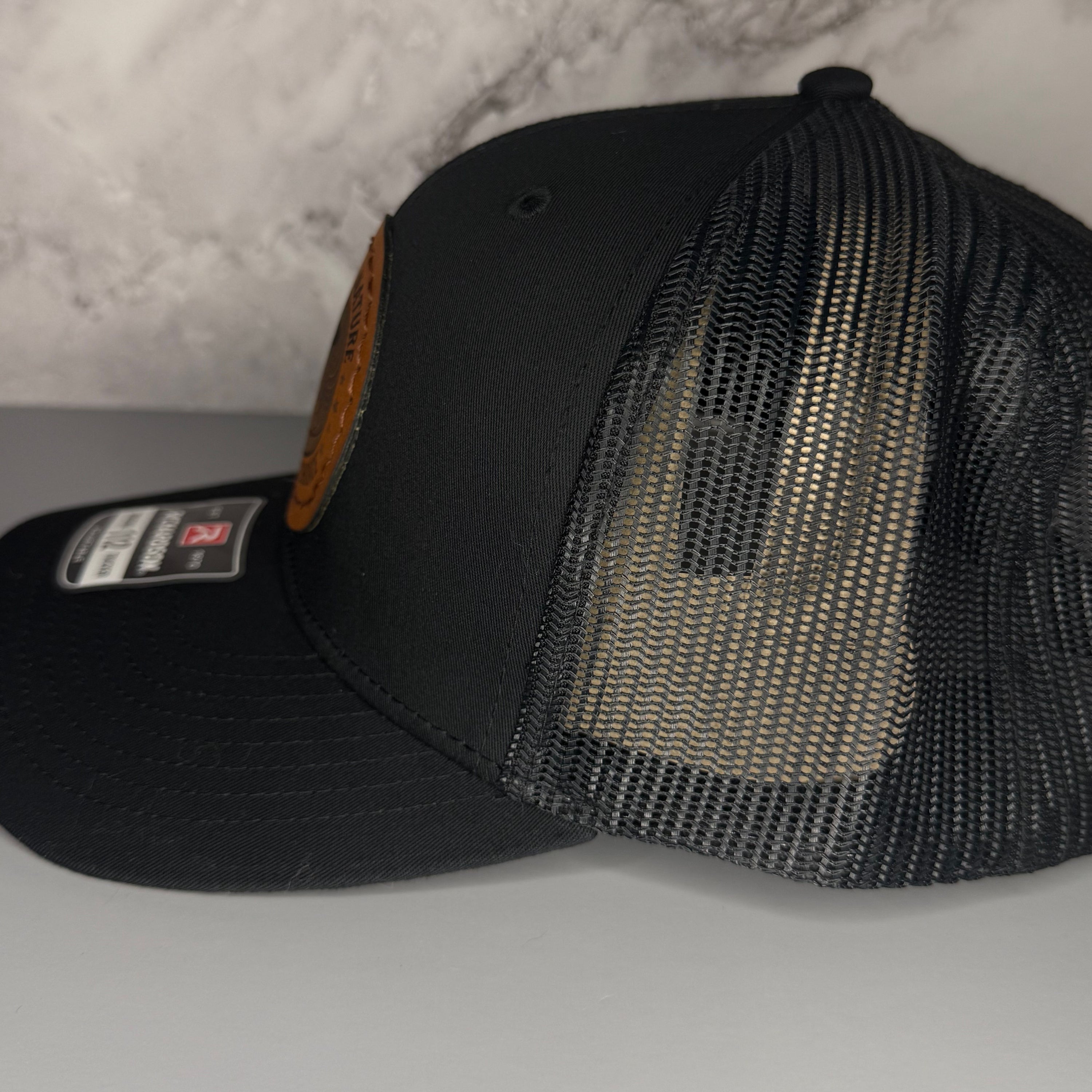 Black mesh cap on a light gray background
