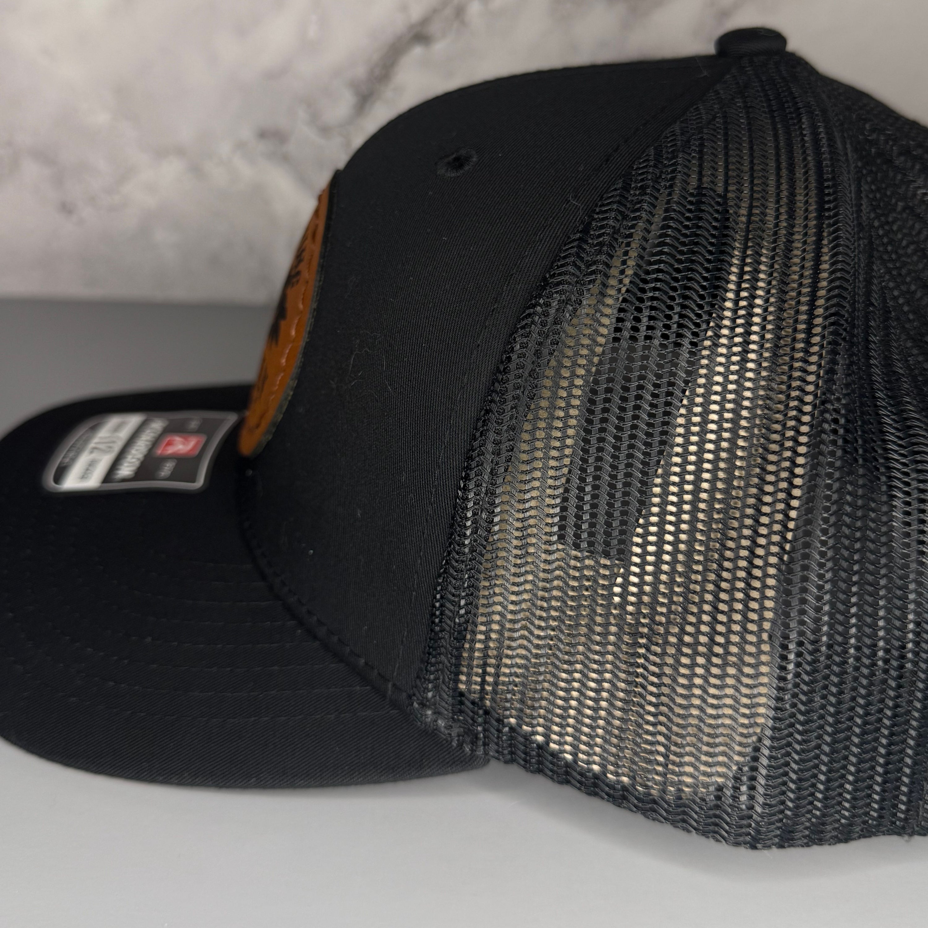 Black mesh cap on a light gray background