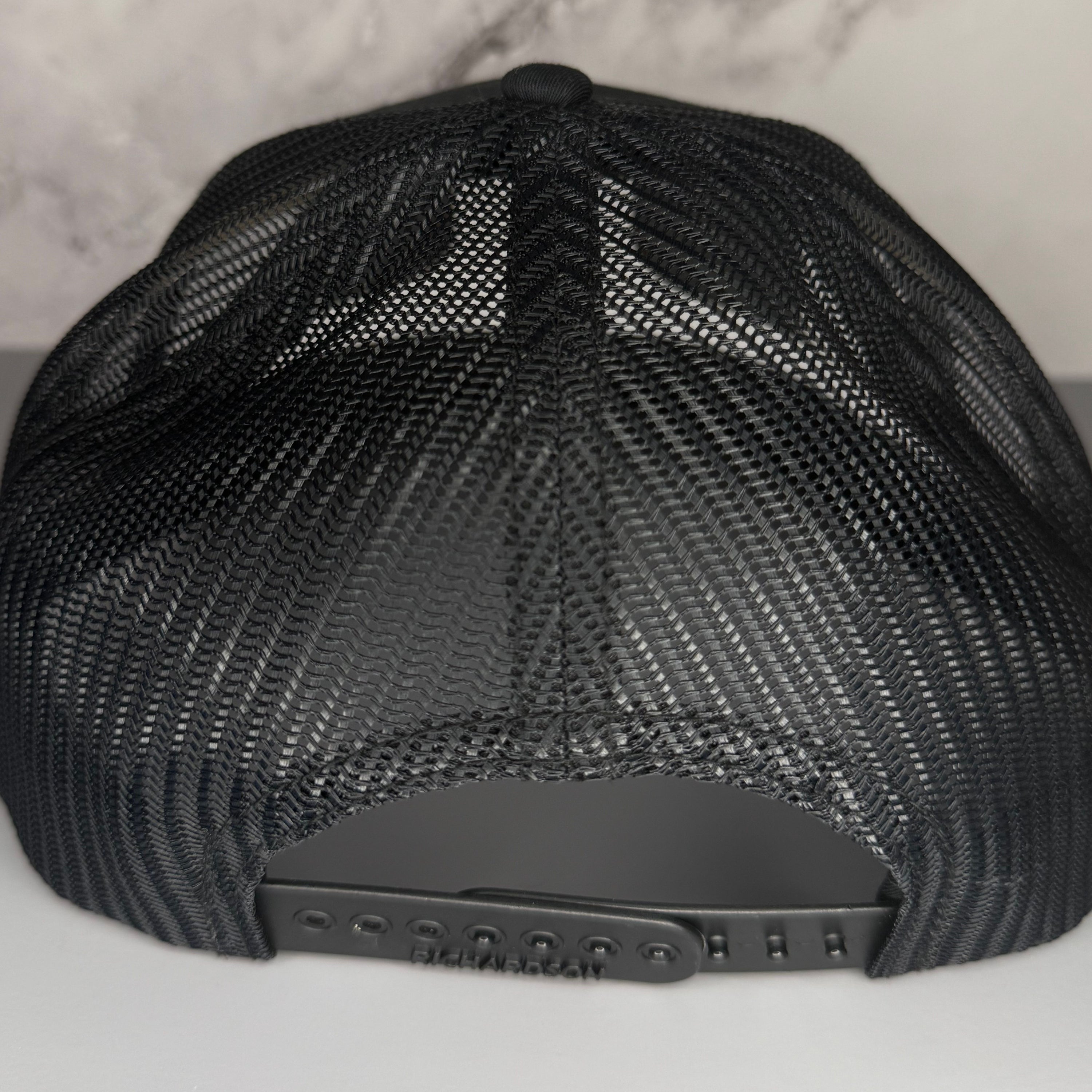 Black mesh cap on a light gray background