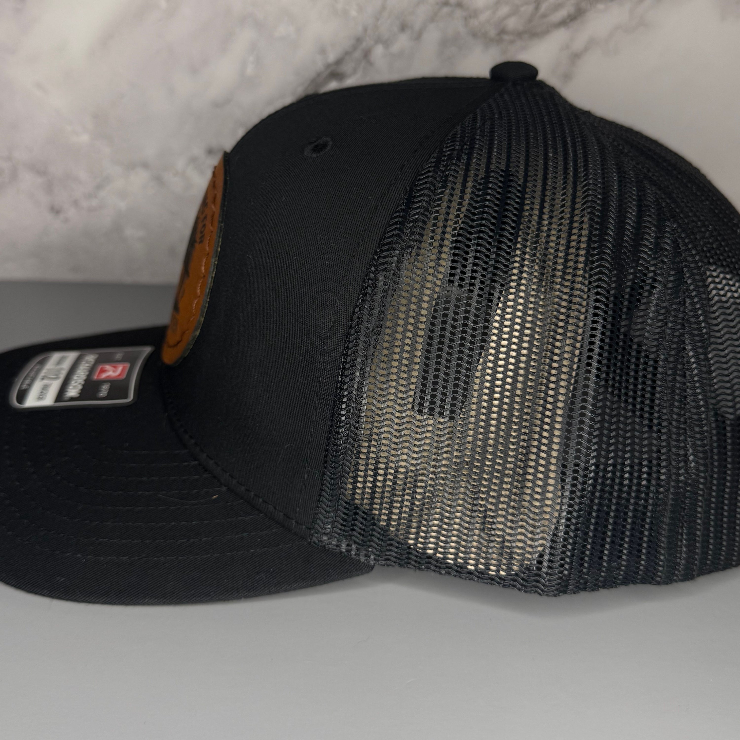 Black mesh cap on a light gray surface