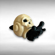 Black 3D printed articulated snail with a beige shell shaped like a human skull, against a gray background