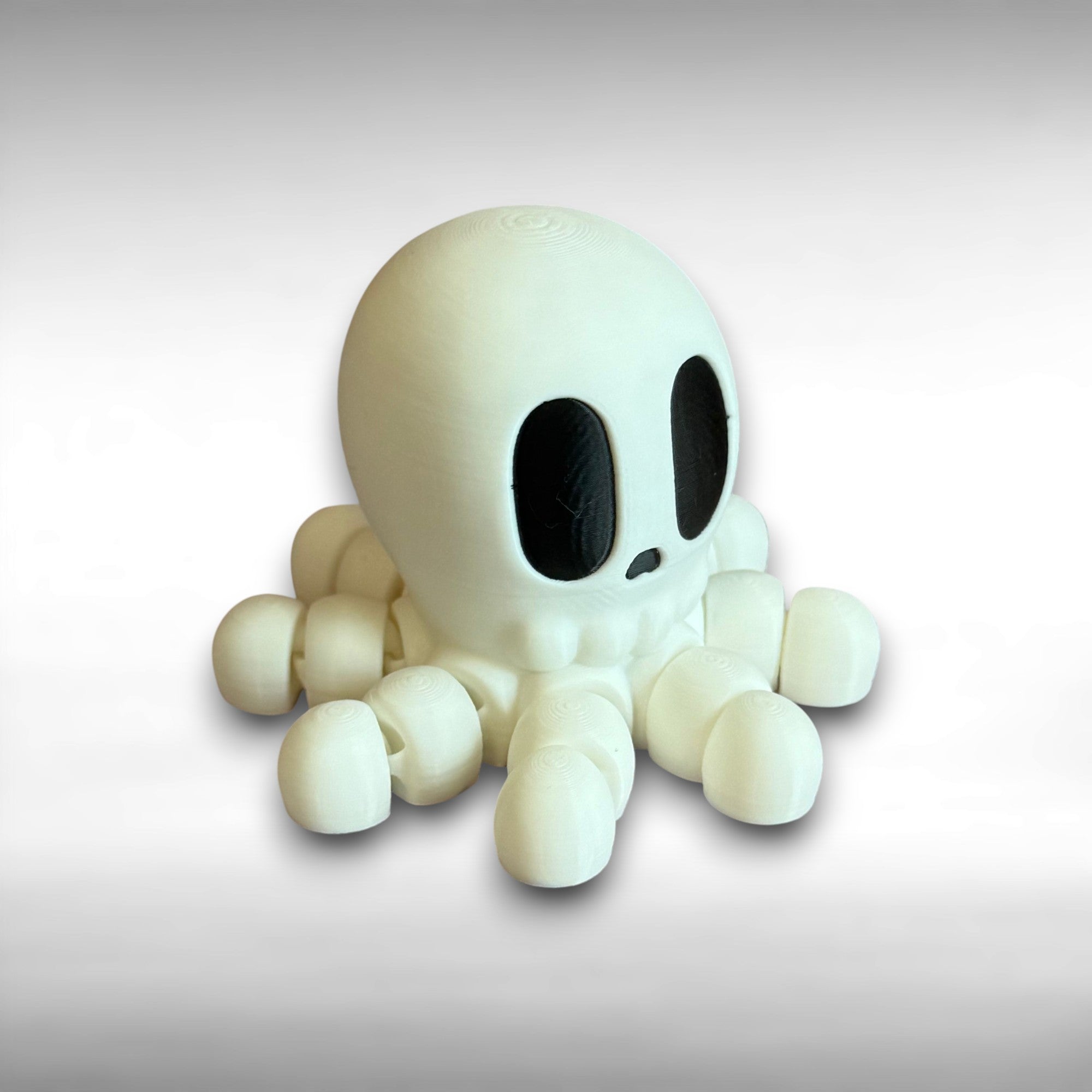 White 3D printed skeleton-like octopus on a gray background