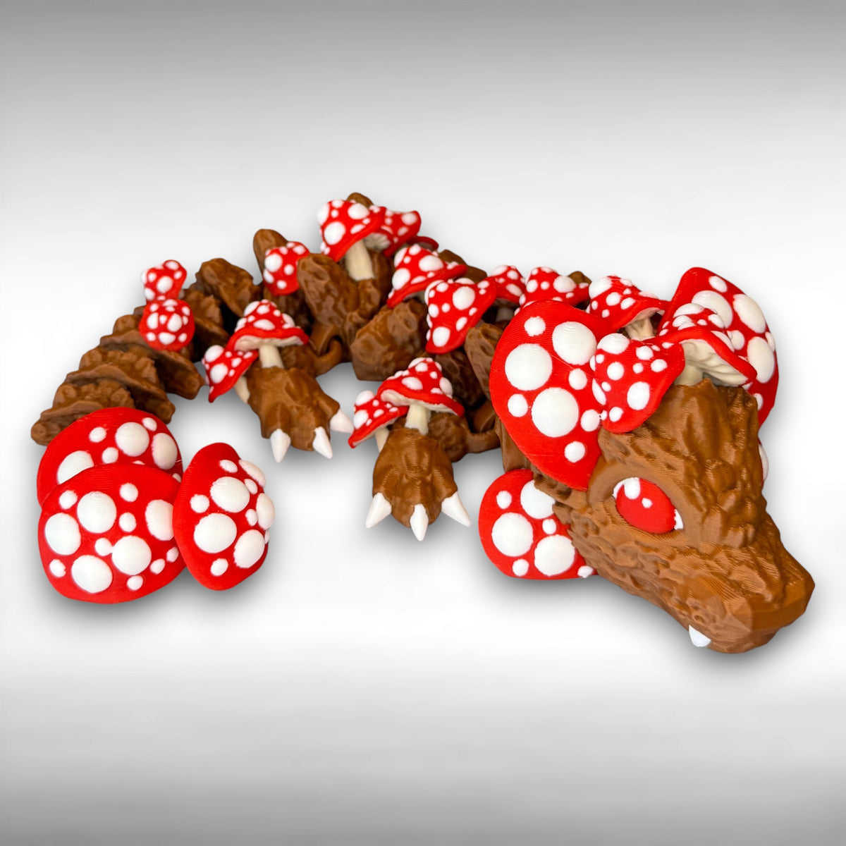 A 12-inch articulated 3D printed dragon with a design resembling a mushroom, with red and white caps on a white background