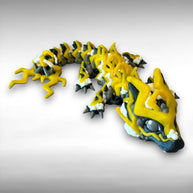 A 3D printed, articulated toy dragon figurine with yellow and black coloring, featuring lightning bolt details and storm cloud patterns, against a white background
