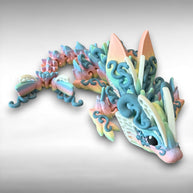 A 3D printed articulated fantasy creature resembling a dragon with butterfly features, in multicolor design, against a white background