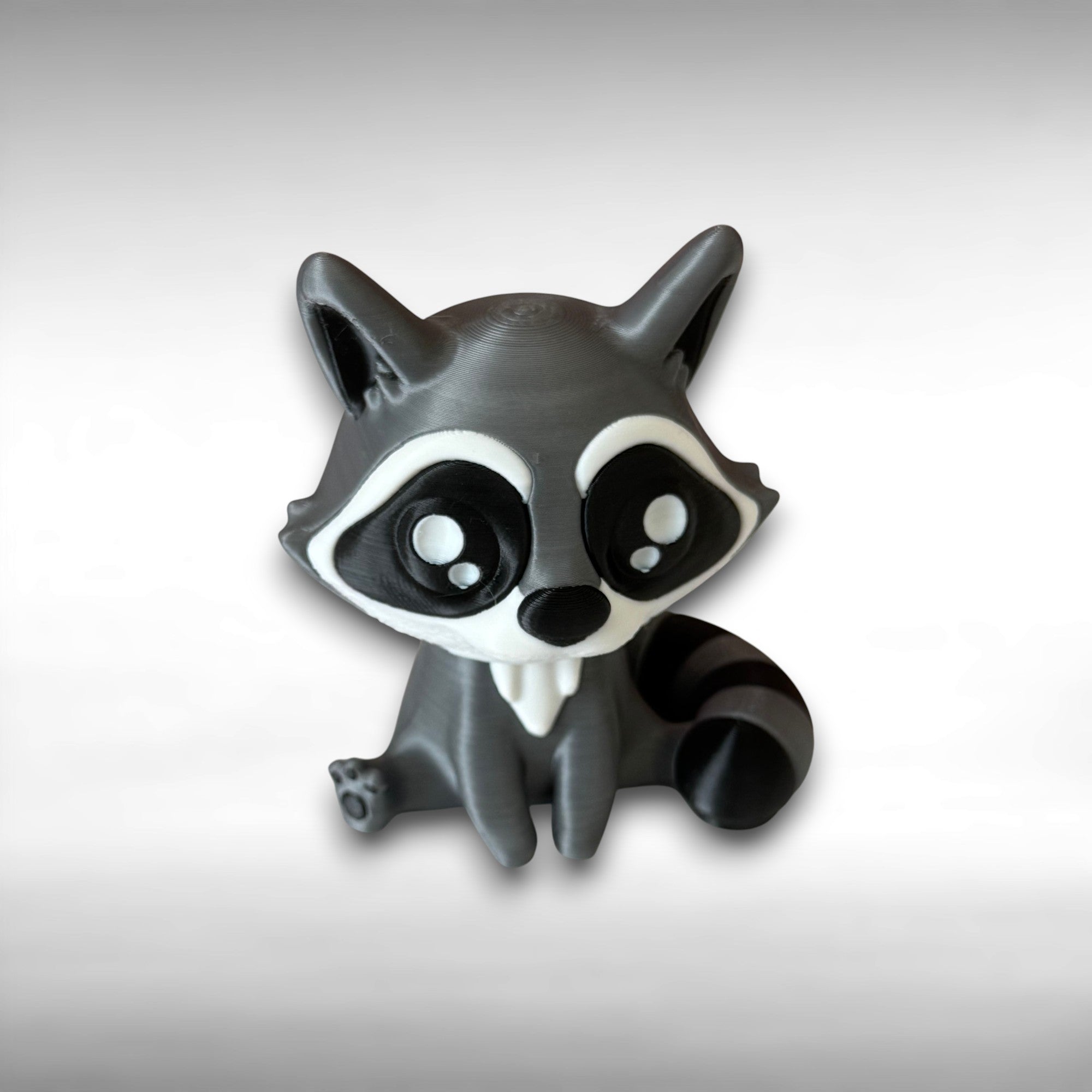Toy raccoon figure on a light gray background