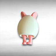 3D printed white egg with pink bunny ears and legs keychain on a white background