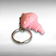 3D Printed pink jellyfish-like keychain with a smiling face against a white background