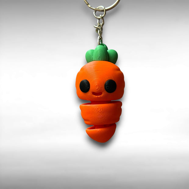 3D printed carrot-shaped keychain with a smiling face on a white background