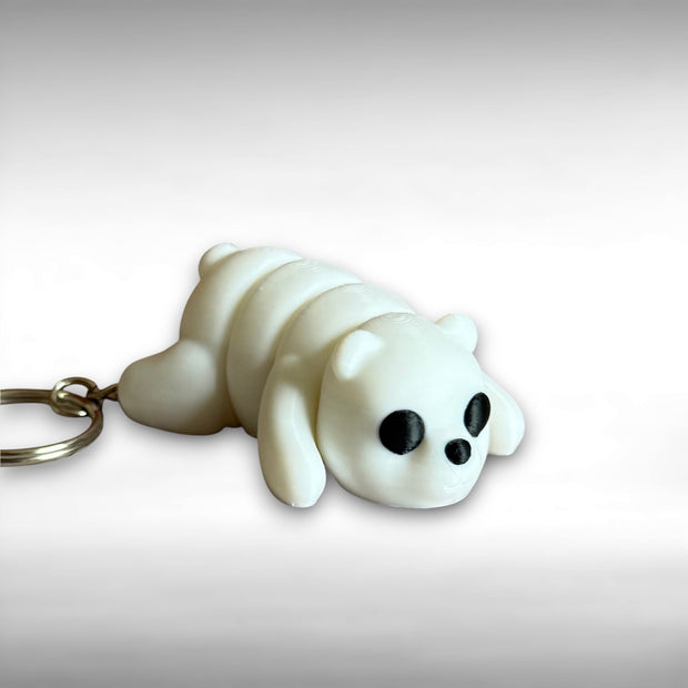3D printed white bear-shaped keychain on a light gray background