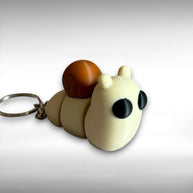 3D printed beige and brown snail-shaped keychain on a white background