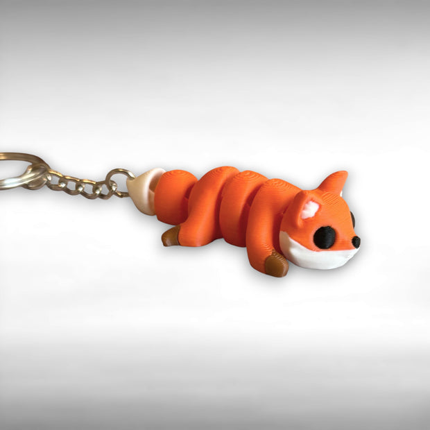3D printed orange fox-shaped keychain on a white background