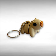 3D printed beige capybara-shaped keychain on a light gray background