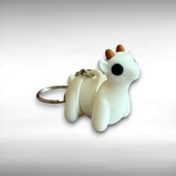 3D printed white goat-shaped keychain with brown horns on a light gray background