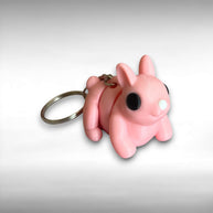 3D printed pink bunny-shaped keychain on a light gray background