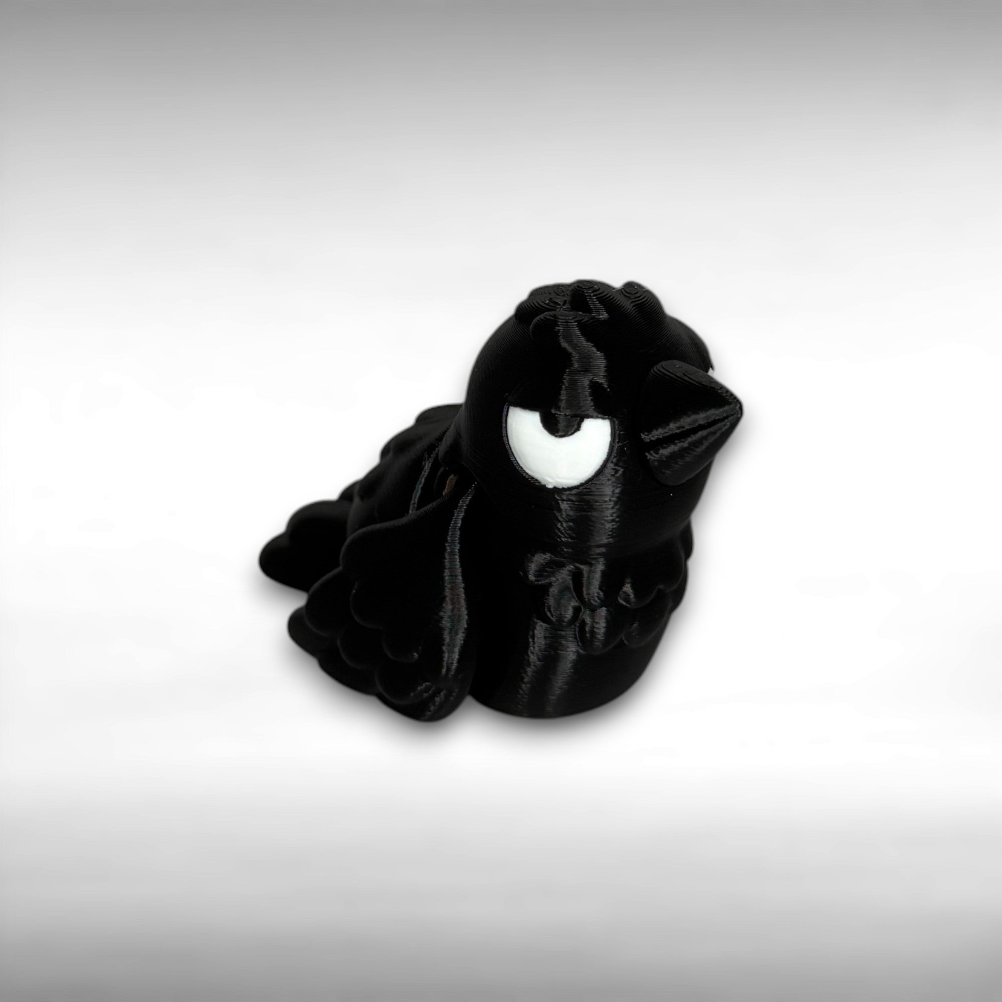 Black crow figure with white eyes on a gray background