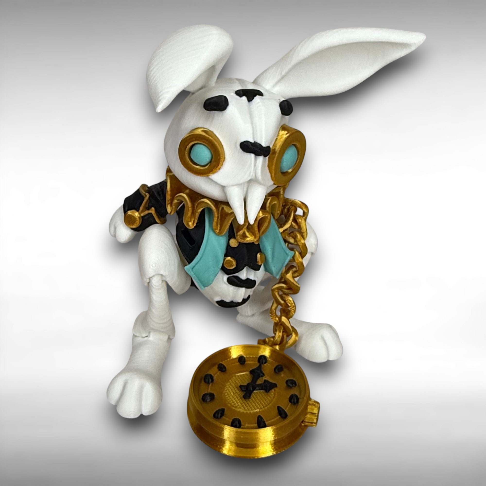 White rabbit figurine with gold and black accessories on a gray background