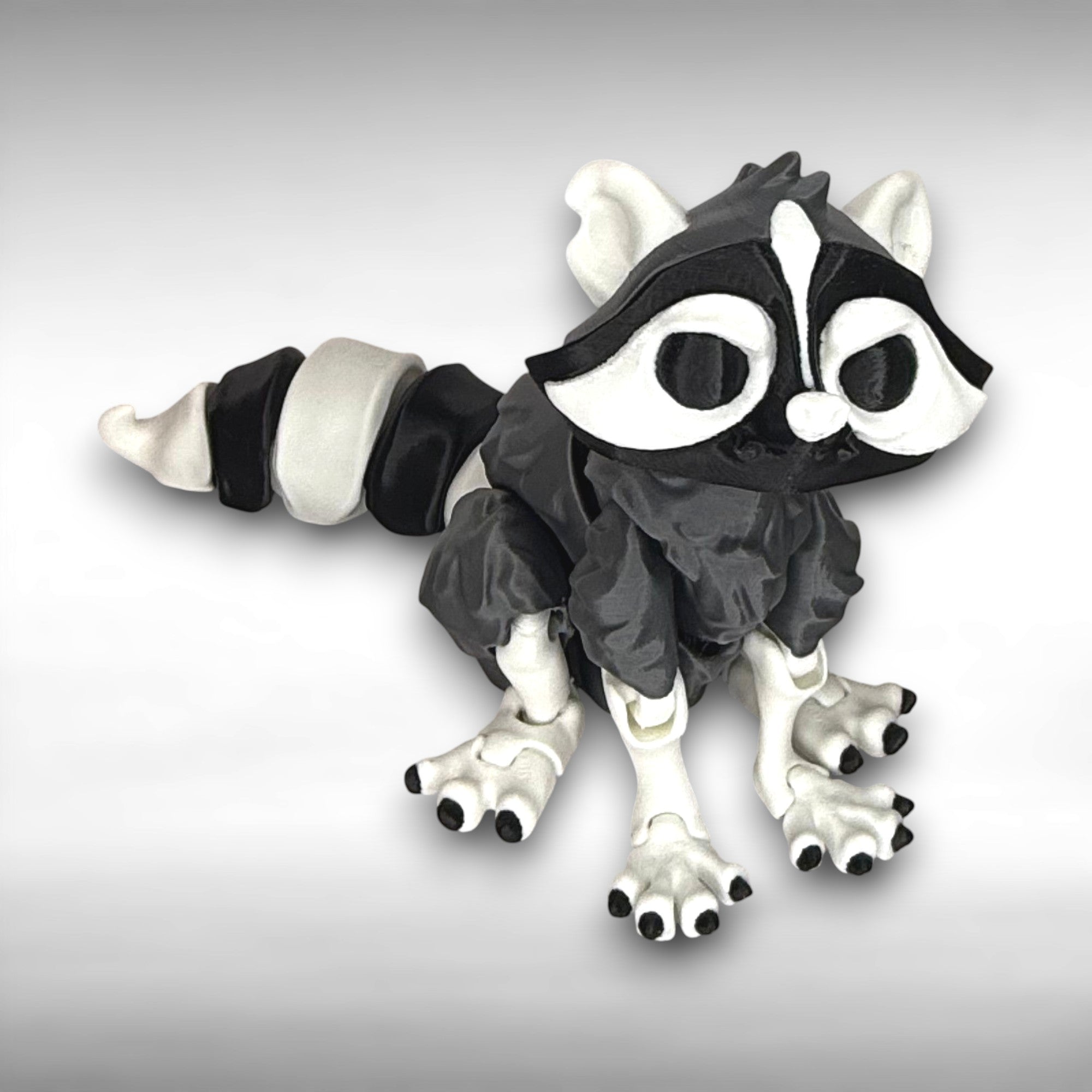 Black and white creature toy on a gray background