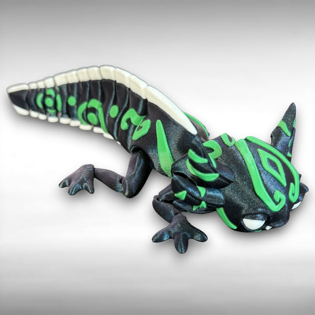 toy axolotl figure with blue, green, and white markings on a gray background