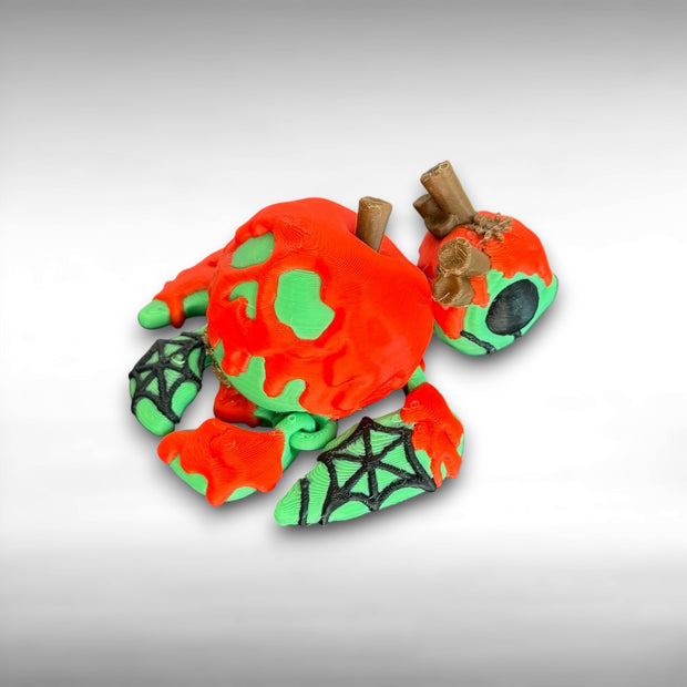 Green and red candy apple themed articulated 3-printed turtle figurine with spider web accents on a white background.