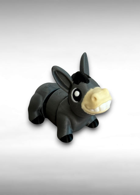 Black and beige donkey-shaped toy on a gray background