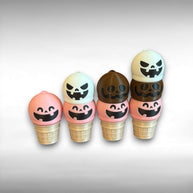 Set of Halloween-themed ice cream cone-shaped keychains with jack-o'-lantern faces on a light gray background.