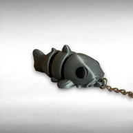 3D printed gray catfish-shaped keychain on a light gray background