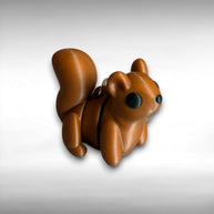 3D printed brown squirrel-shaped keychain on a light gray background
