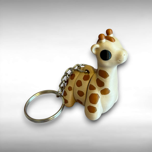3D printed beige and brown giraffe-shaped keychain on a light gray background