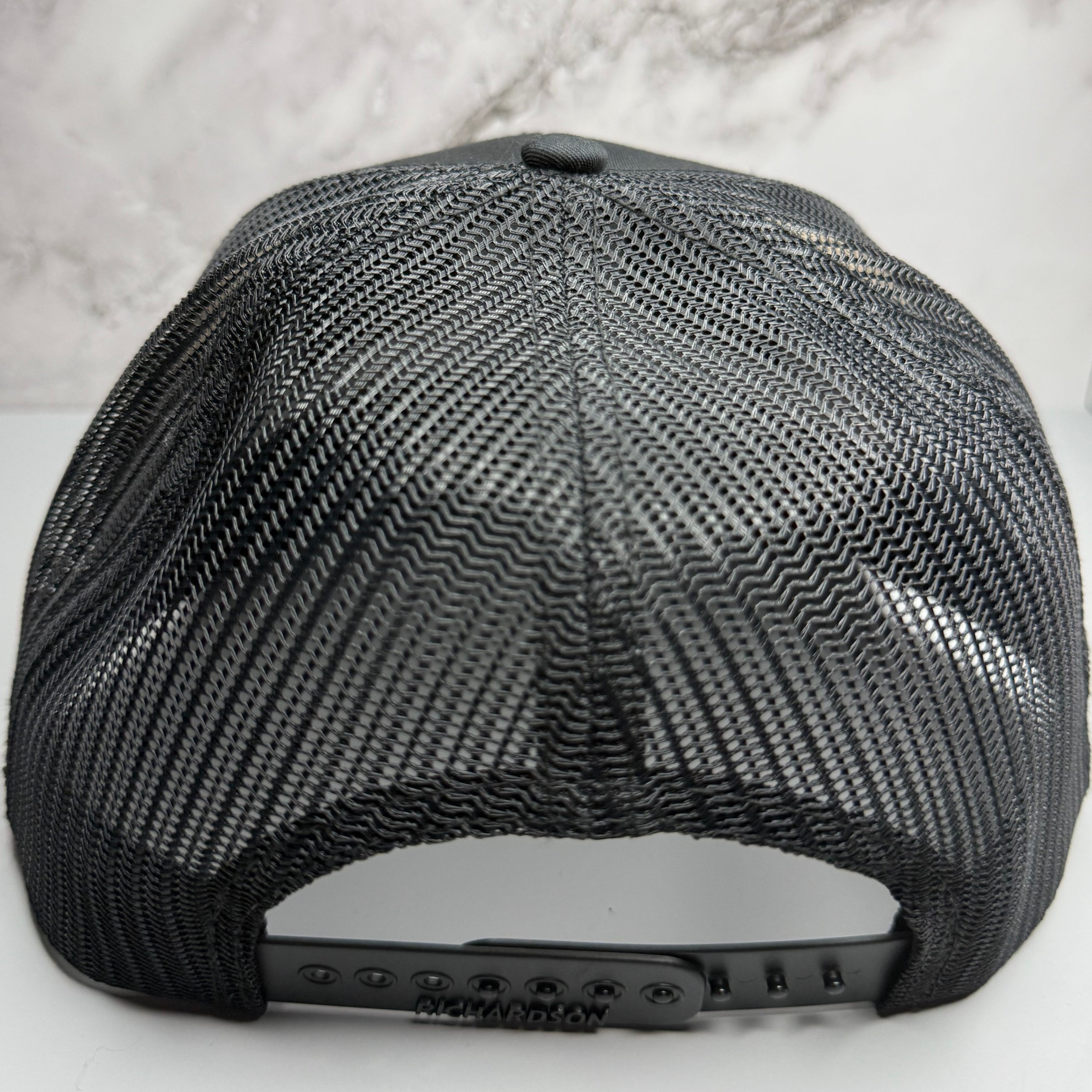Black mesh cap on a light gray background