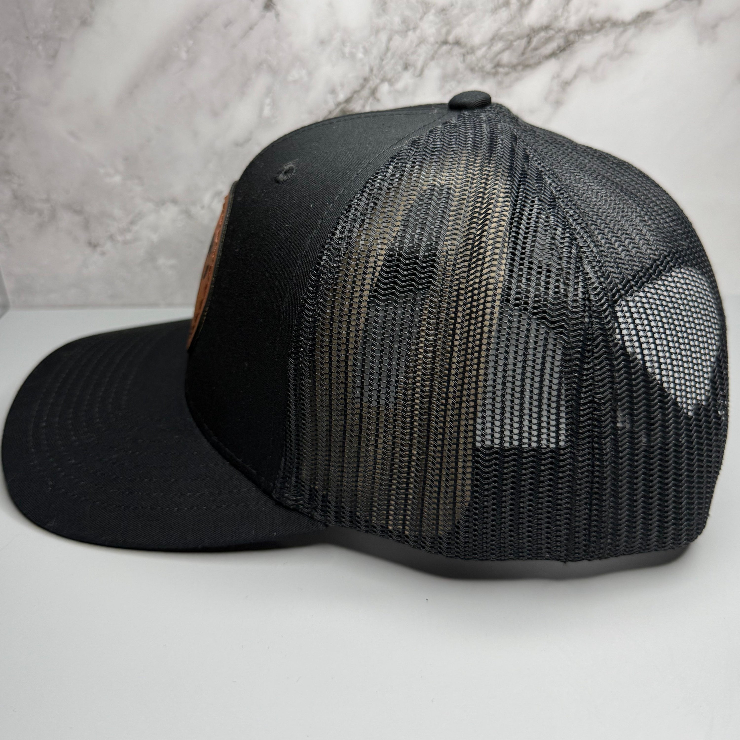 Black mesh cap on a light gray background