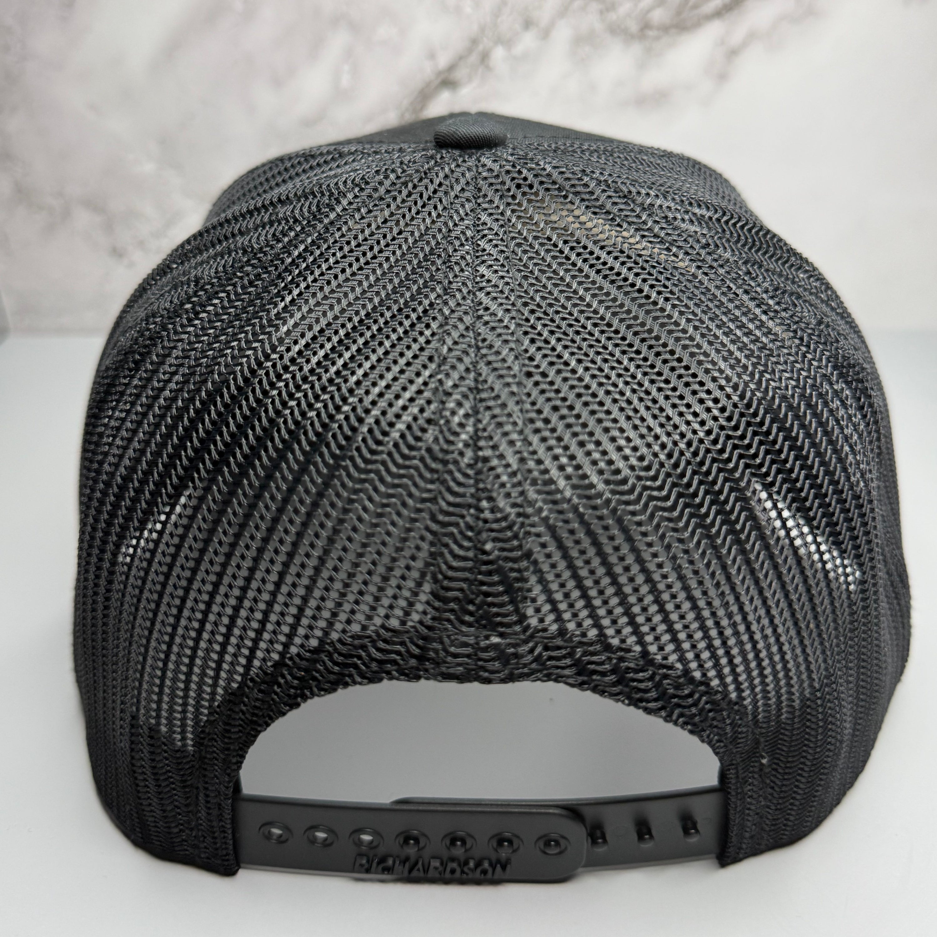Black mesh cap on a light gray background