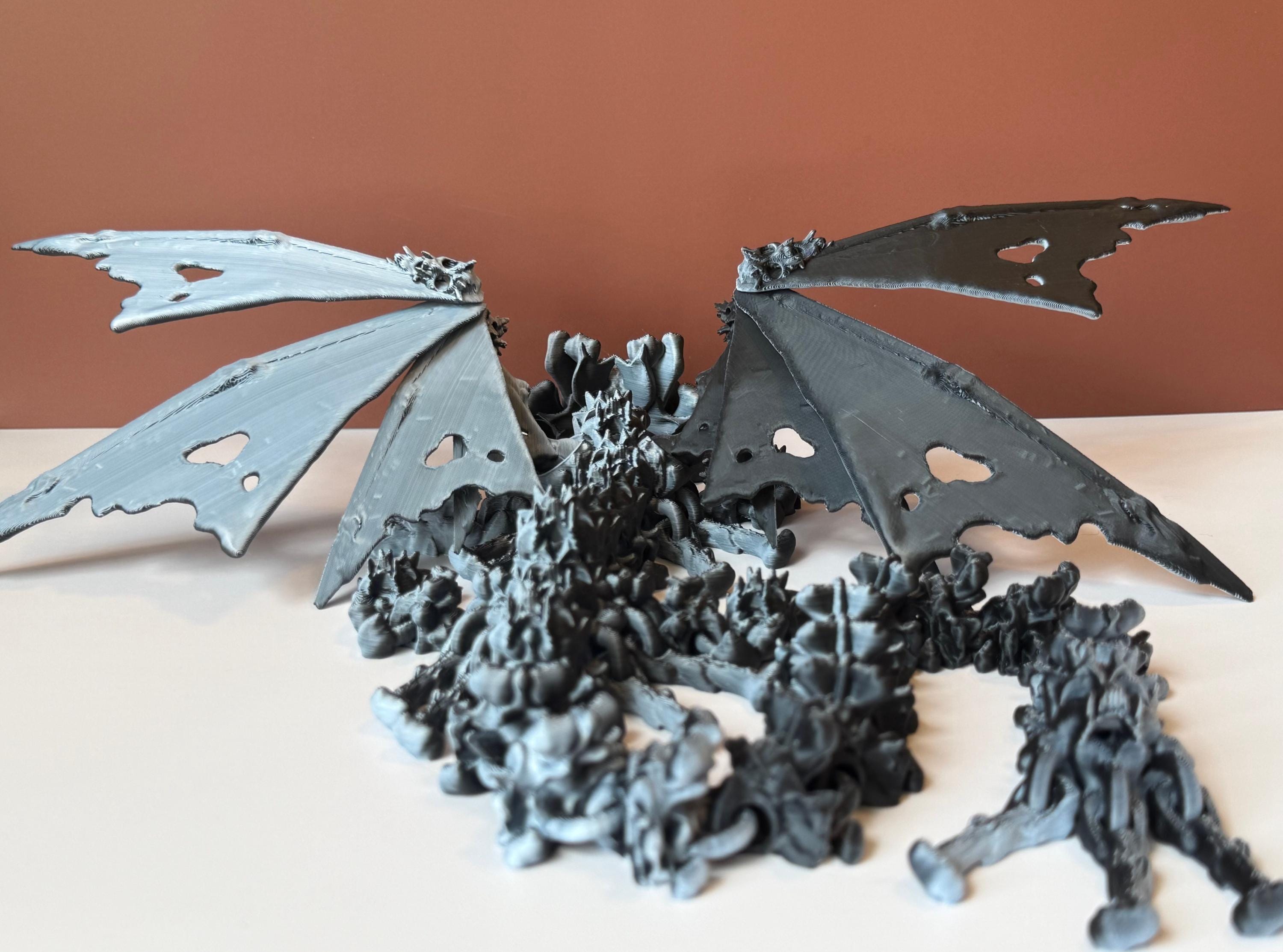 Winged black and white 3d printed dragon with a hollow theme consisting of skulls and bone-like features against a white and brown background