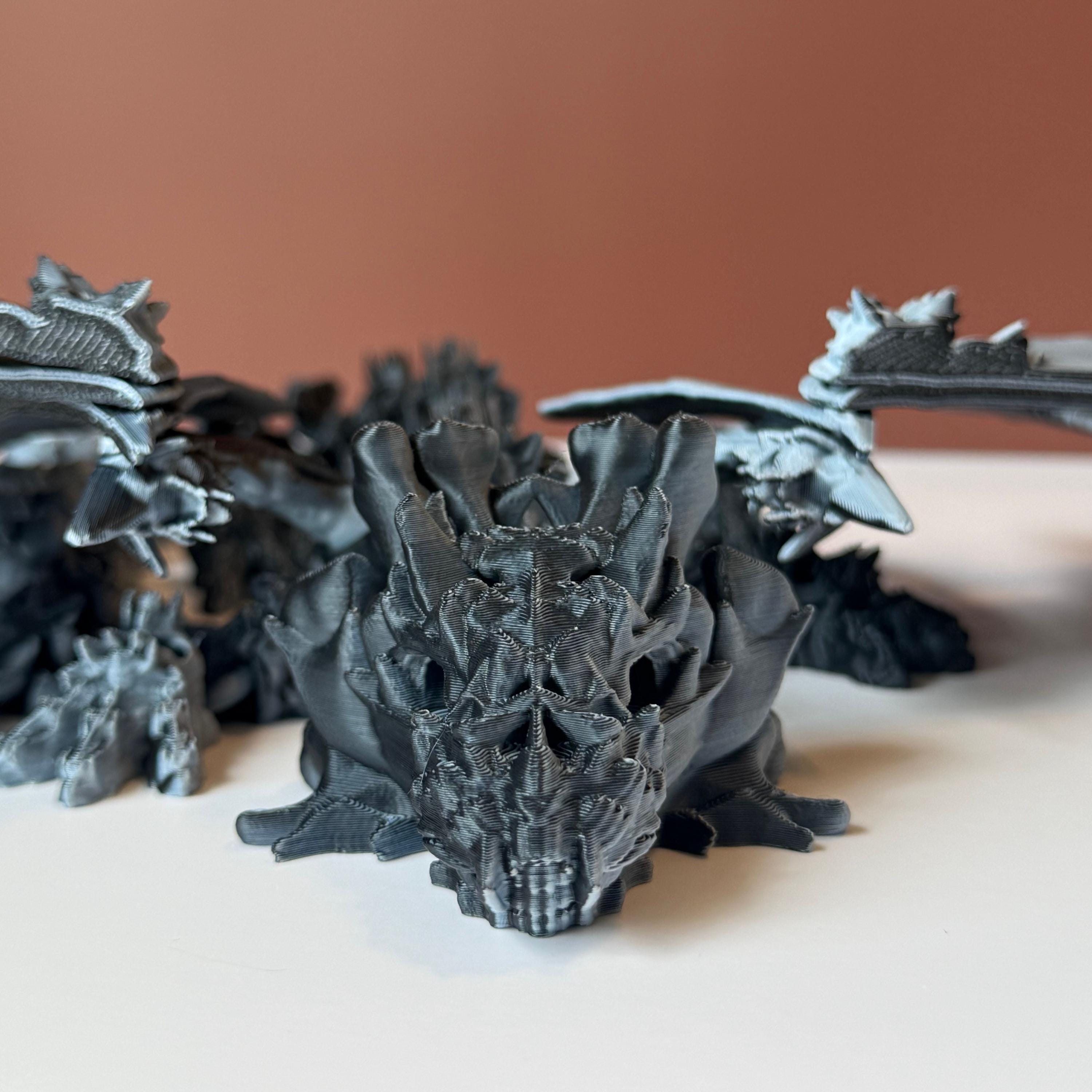 Winged black and white 3d printed dragon with a hollow theme consisting of skulls and bone-like features against a white and brown background