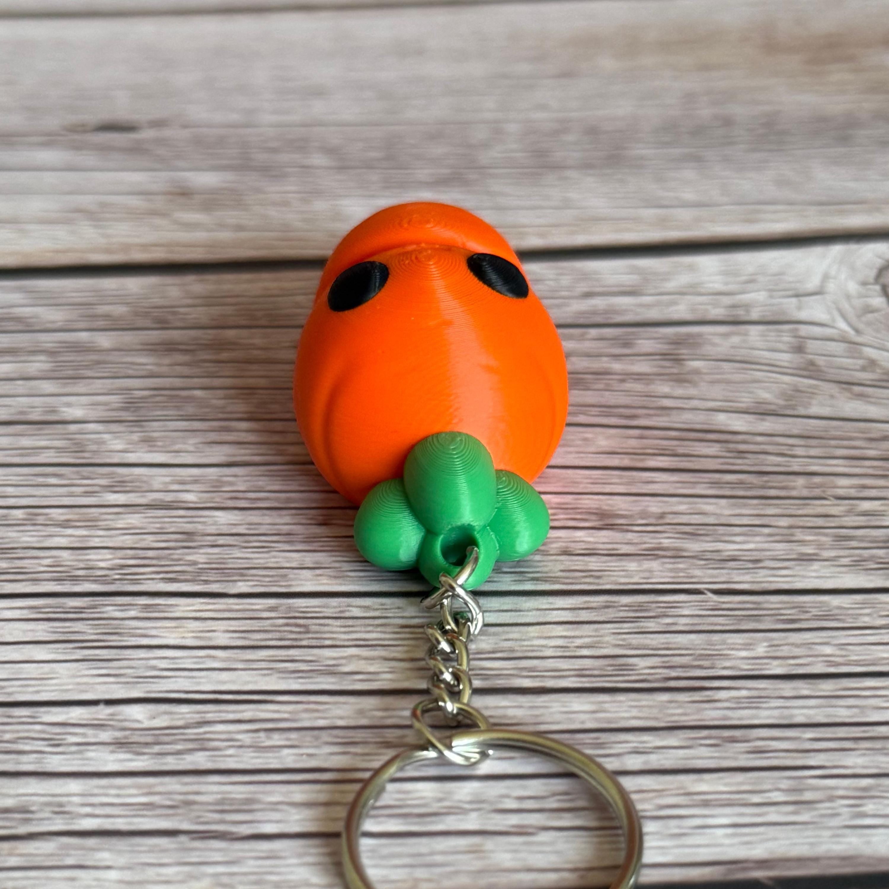Top of a 3D printed carrot-shaped keychain on a wooden surface